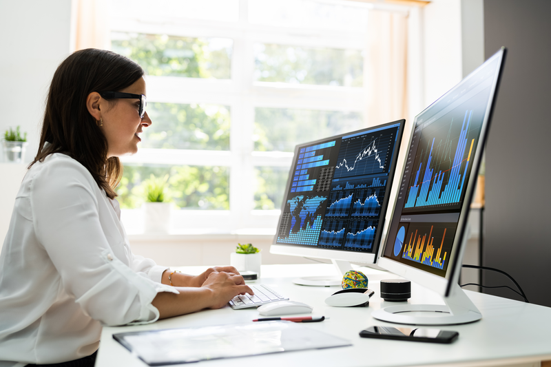Female analyst looking at data on screen