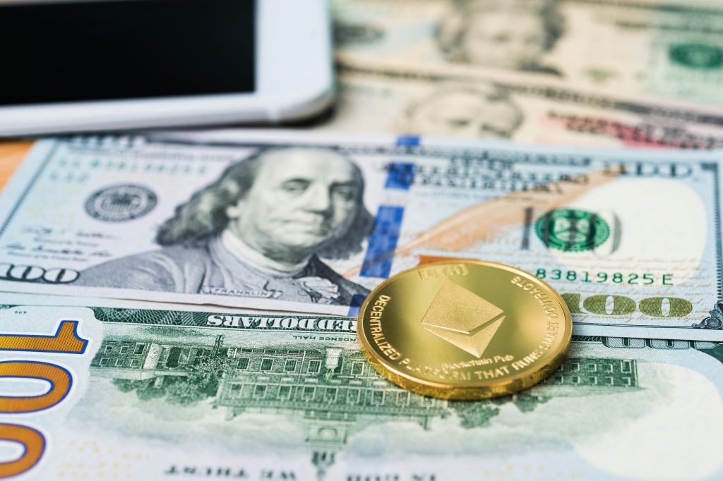 Ethereum coins, US dollars, mobile phone