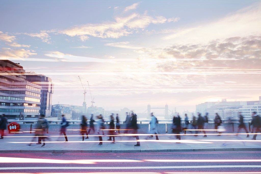 People walking across bridge in London