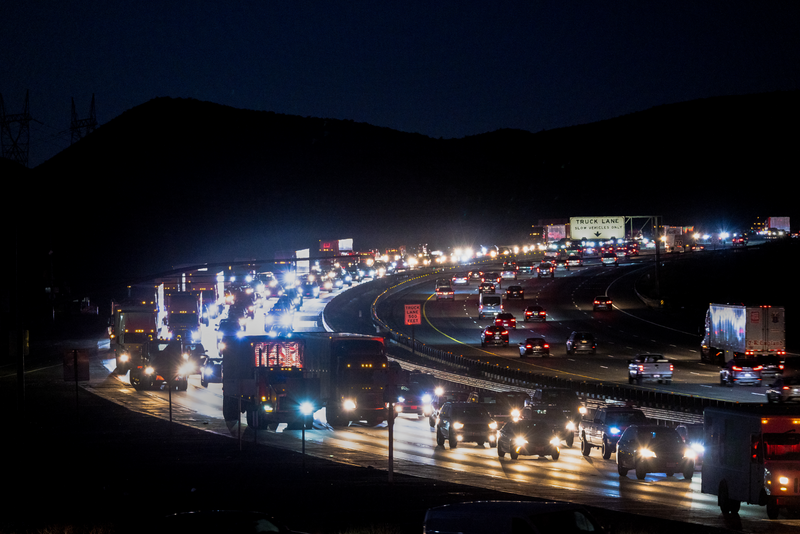 US road with heavy traffic at night.