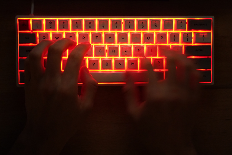 A computer keyboard with red light underneath, which signals danger.