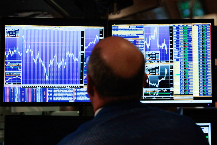 A financial professional looks at his computer screen