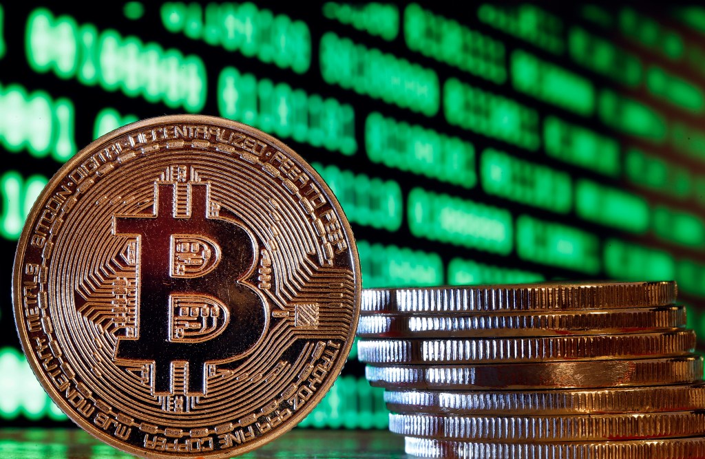 Image of a Bitcoin against a green digital screen