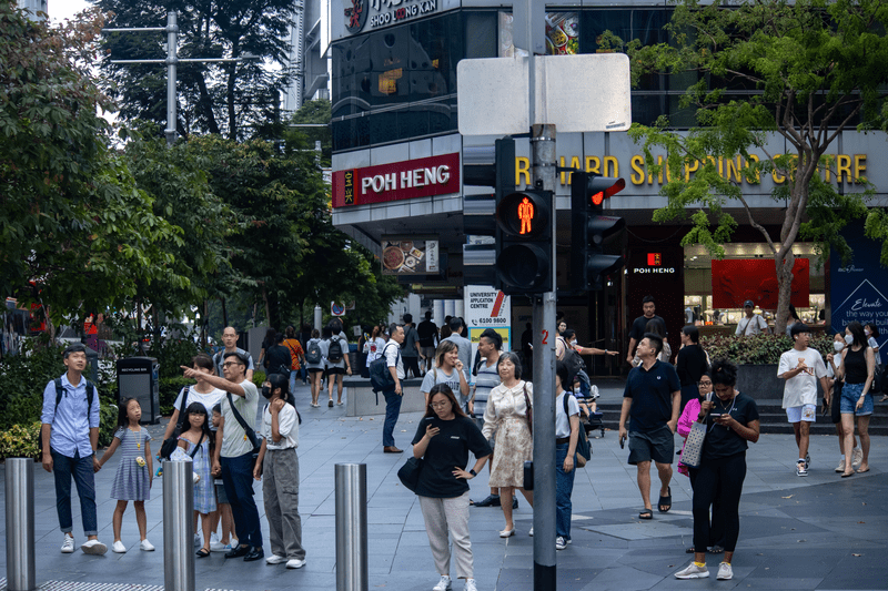 People walk on the street in Singapore.