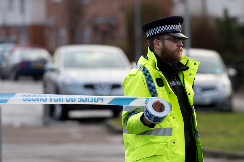 A police officer puts up a cordon
