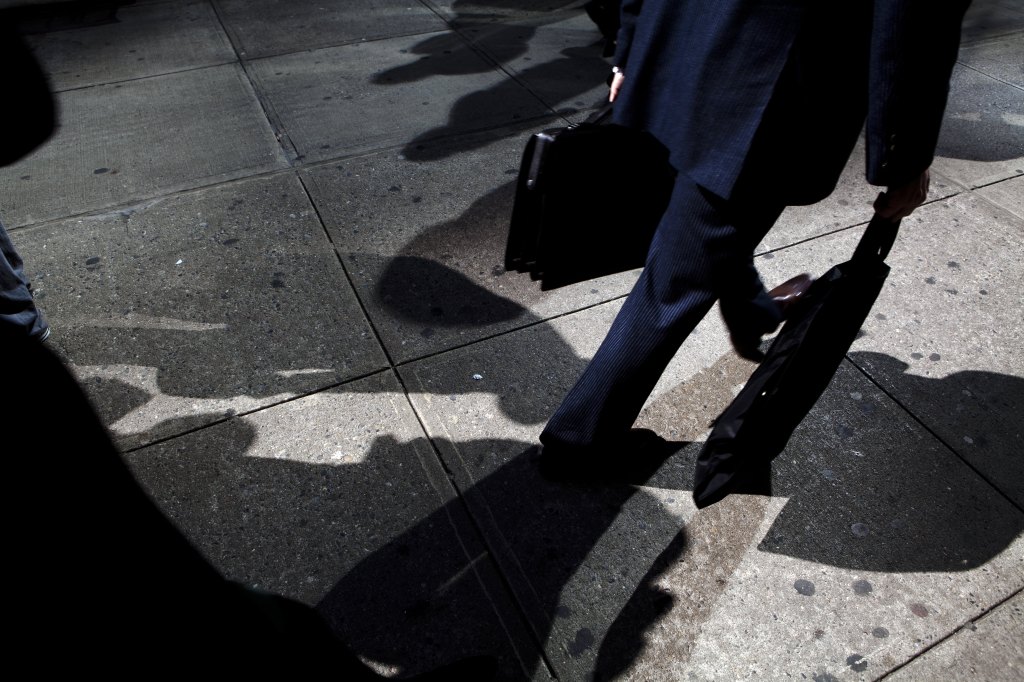 Suits walk by the more causally dressed on the streets of Manhattan.