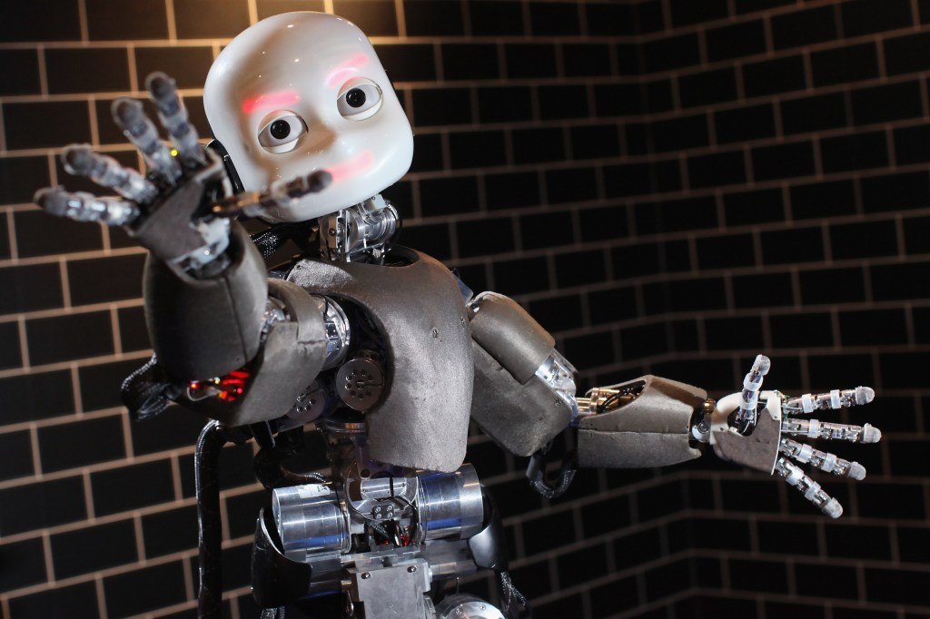 Image of a robot with its arm stretched out.