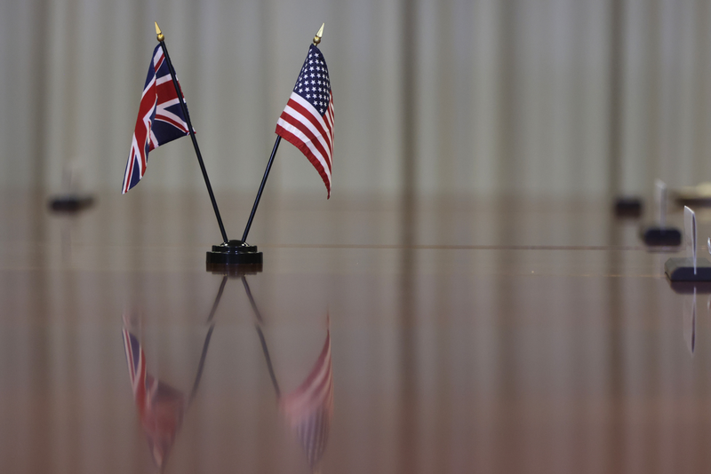 A U.S. flag and an Union Jack are placed on the conference table