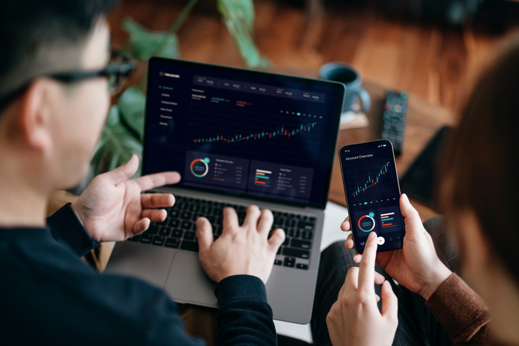 Couple managing finances on screen