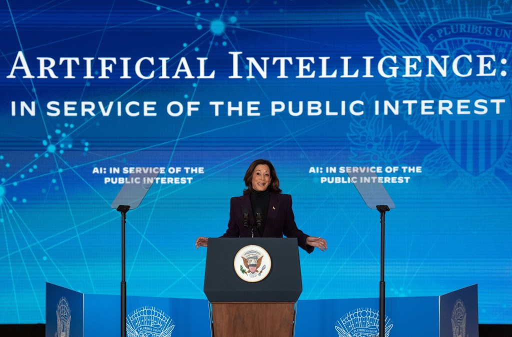 Kamala Harris in front of 'AI In The Service of the Punlic Intrest' sign
