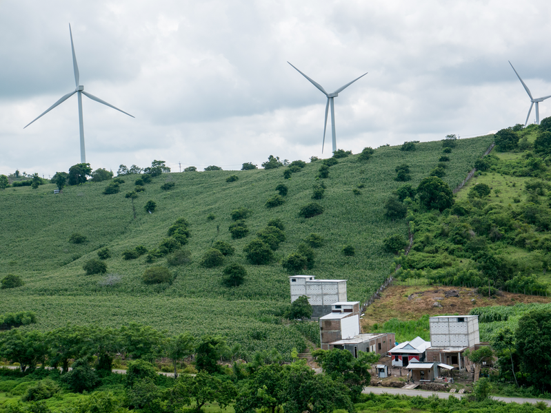 Sidenreng Rappang, Indonesia - January 23, 2020 : The view of Indonesian wind farm on a green hilly area.