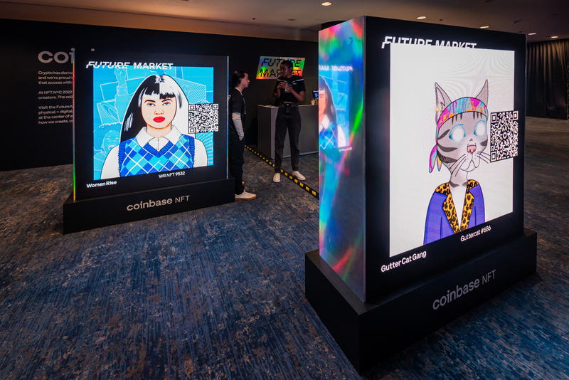 NFTs are displayed at the Coinbase booth at the 4th annual NFT.NYC conference