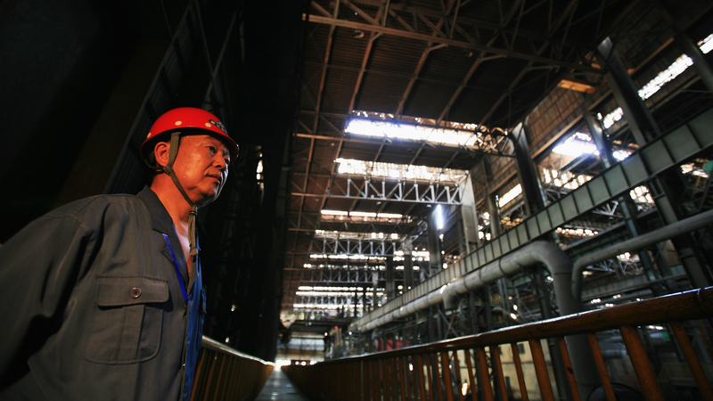 A worker stands inside the Shougang Capital Iron and Steel Plant on in Beijing, China. 