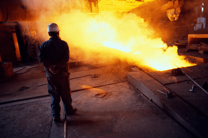 Workers monitor the blast furnace at the Bao steel mill in Baotou, Inner Mongolia, China.