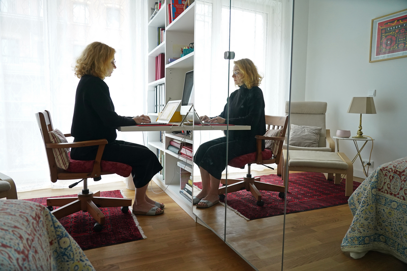 Woman working from home on desk in her bedroom