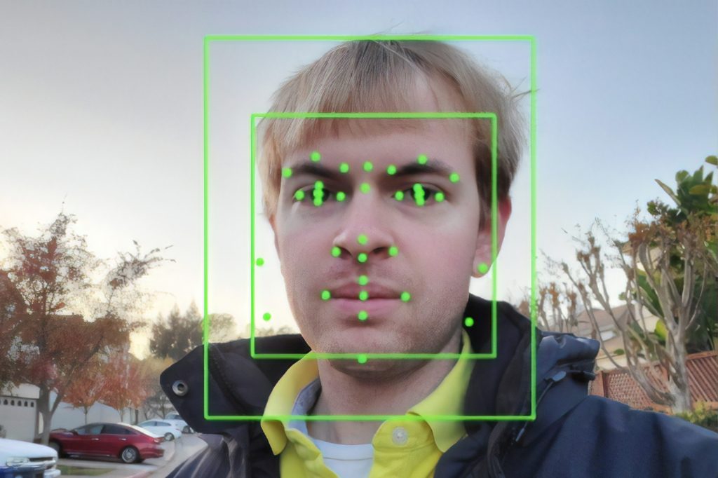 Image of a young man with some electronic lines around his face in two squares.