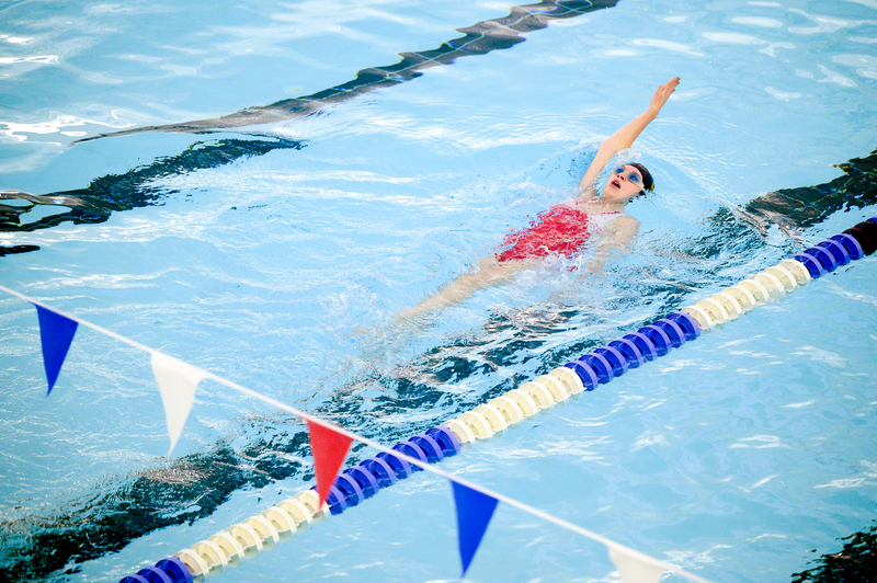 A woman swims in a pool.