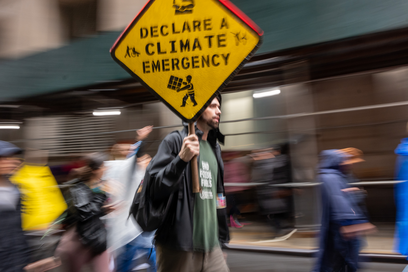 People involved in climate activism hold a demonstration in the Financial District of Manhattan