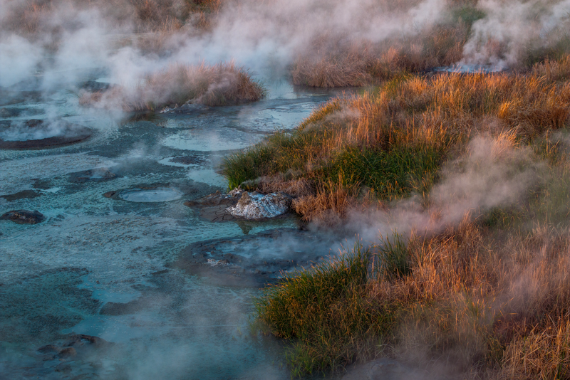 Steam rises from fumaroles, or steam vents, situated between two of the five Salton Buttes lava dome volcanoes that line the southeastern edge of the Salton Sea and are heated by magma under the Salton Sea Geothermal Field near Niland, California.