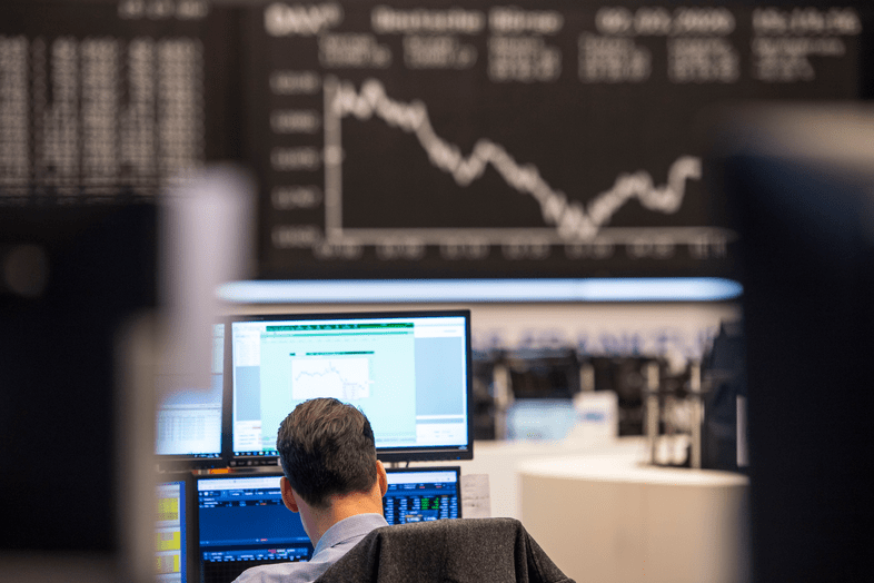 A trader sits in desk pods on the trading floor.