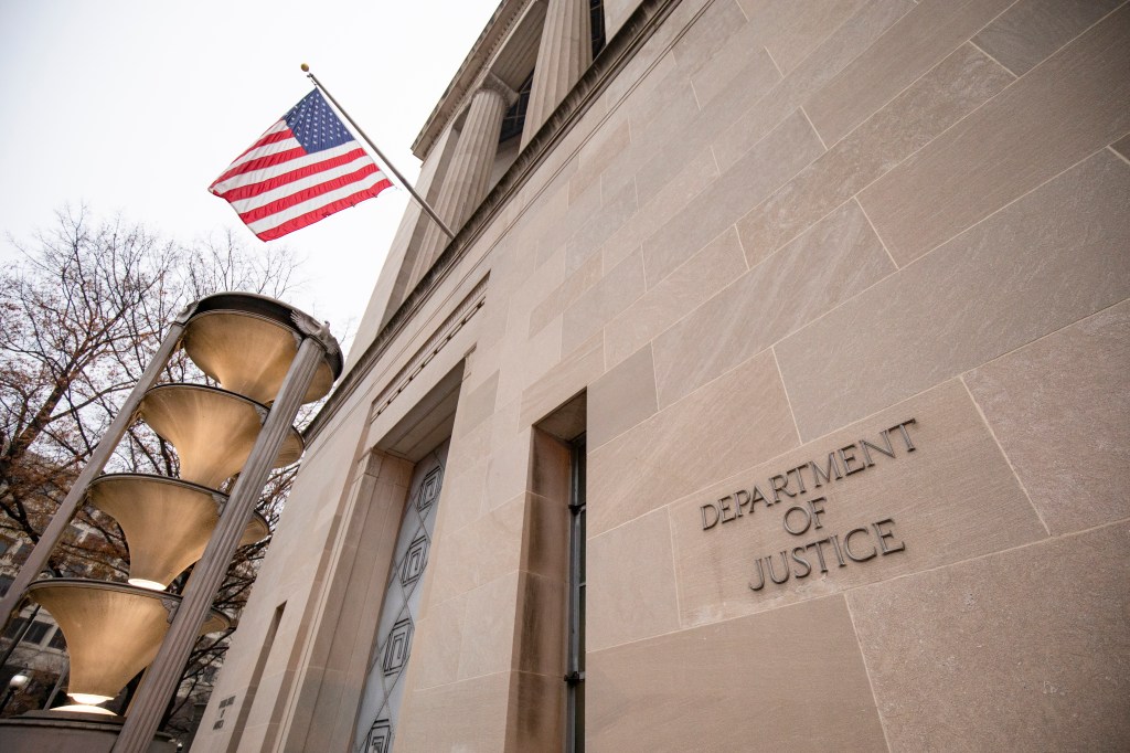 Image of front of DOJ main headquarters with DOJ inscribed on the facade.