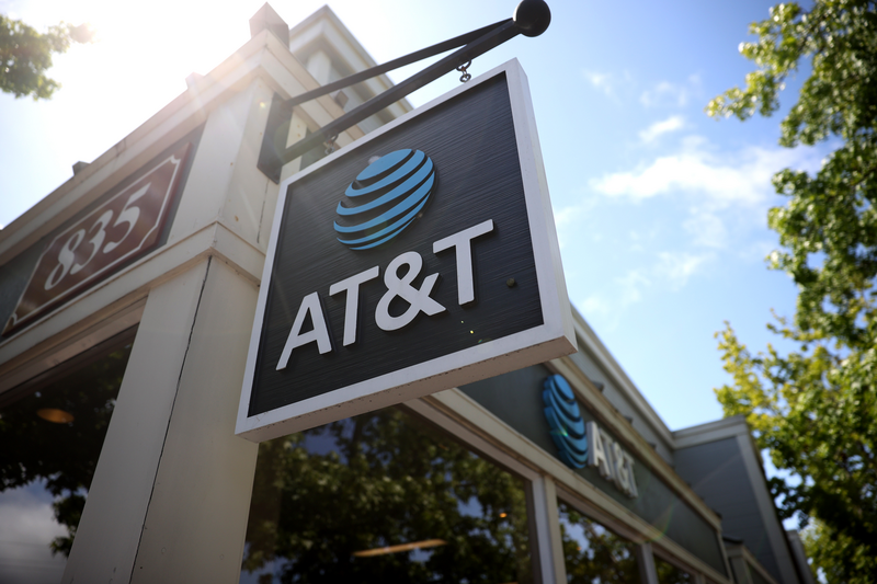 A sign is posted in front of an AT&T retails store.