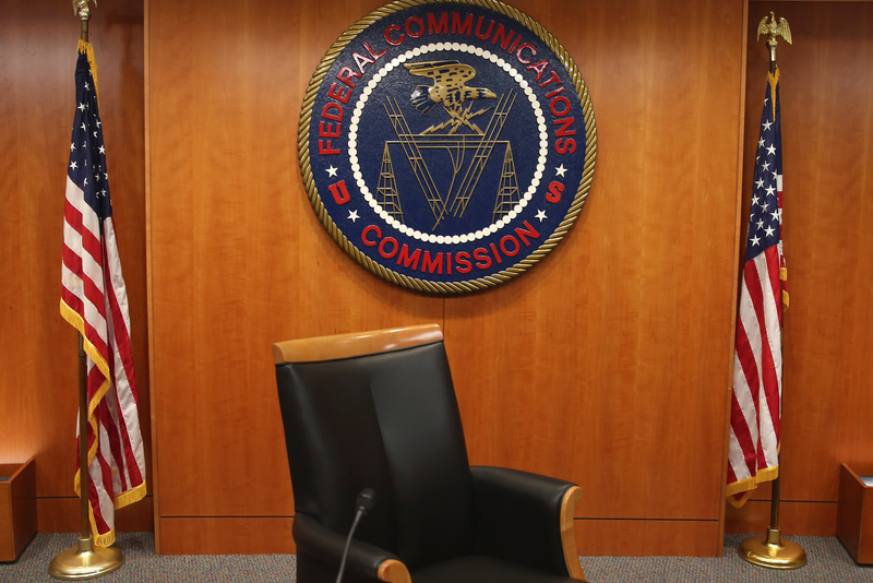 The seal of the Federal Communications Commission hangs behind a chair inside the hearing room at the FCC headquarters in Washington, DC.