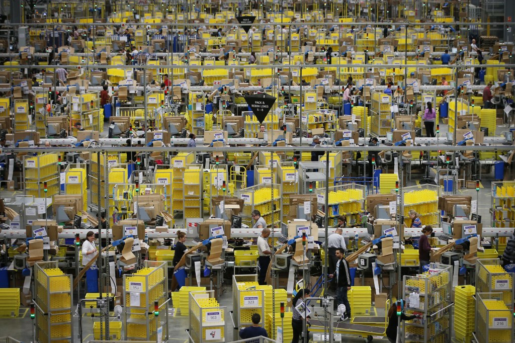 Image of a warehouse floor with a large group of employees assembled.