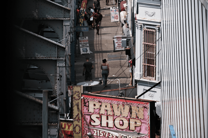 People gather on a street overtaken by heroin users in Kensington on July 19, 2021 in Philadelphia, Pennsylvania. According to data from the US Centers for Disease Control and Prevention's National Center for Health Statistics, over 93,000 people died from a drug overdose last year in America. These numbers and the continued rise in opioid use made 2020 the deadliest year on record for drug overdoses. Officials have said that the increase is being driven by the lethal prevalence of fentanyl and stressed Americans due to the Covid pandemic. Kensington, a neighborhood in Philadelphia, has become one of the largest open-air heroin markets in the United States.