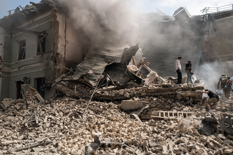 People search for victims after the Russian army launched a rocket attack on the "Ohmatdyt" children's clinic on July 8, 2024 in Kyiv, Ukraine. Kyiv's Mayor Vitali Klitschko urged residents to stay in shelters this morning as several explosions were heard around the capital.
