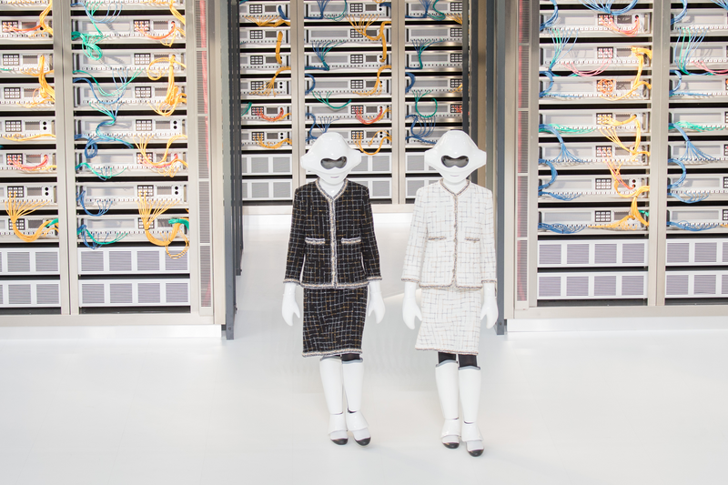 Models with android masks walk the runway during the Chanel show.