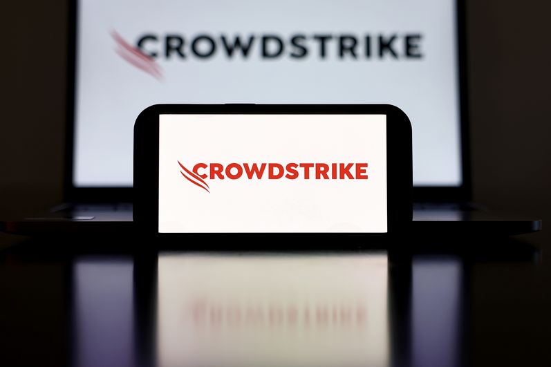 In this photo illustration, the CrowdStrike logo is displayed on a cell phone and computer monitor on July 19, 2024.