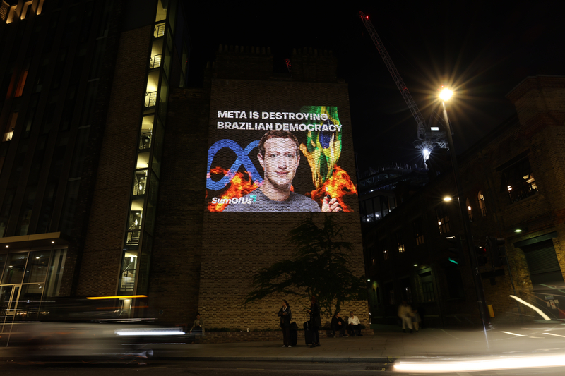 Activists project an image of Mark Zuckerberg onto a wall outside Kings Cross St. Pancras on October 29, 2022 in London, England. The projection's organiser, SumOfUs, accused the social media company and its founder Mark Zuckerberg of "destroying Brazilian democracy" by letting disinformation propagate on its platforms. 