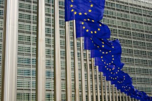 EU flags in Brussels in front of European Commission and Parliament.