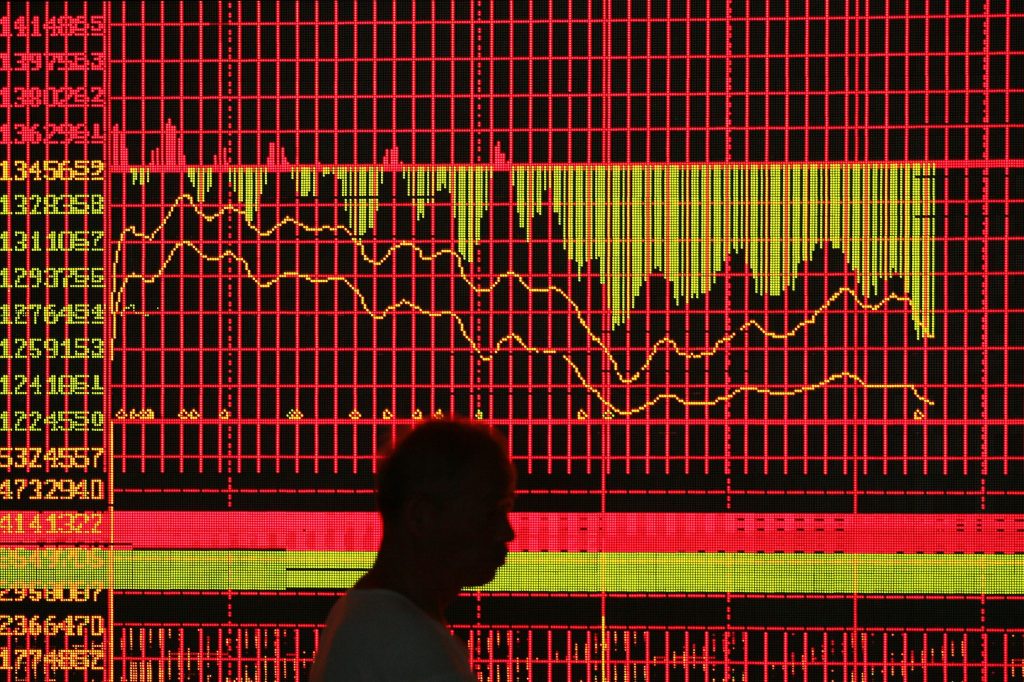 Image of a man walking in front of a graph showing investment returns.