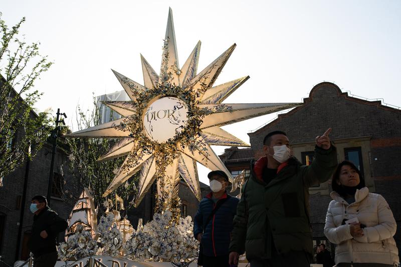 Pedestrians walks past a huge Christian Dior installation at a shopping mall on December 14, 2022 in Shanghai, China.