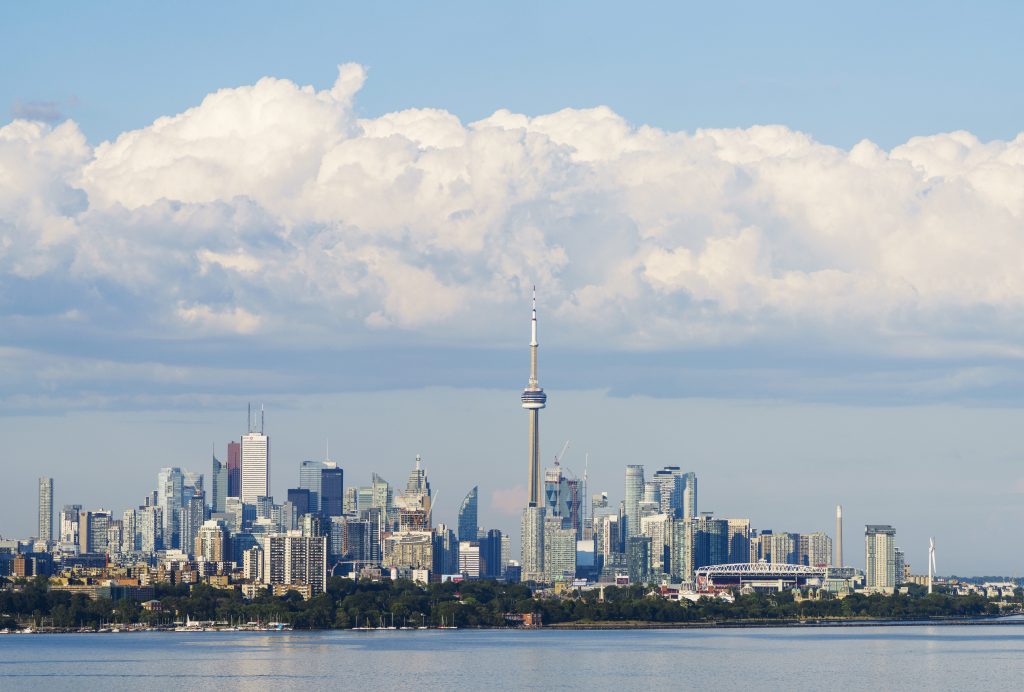 A photo of the Toronto skyline with clouds above