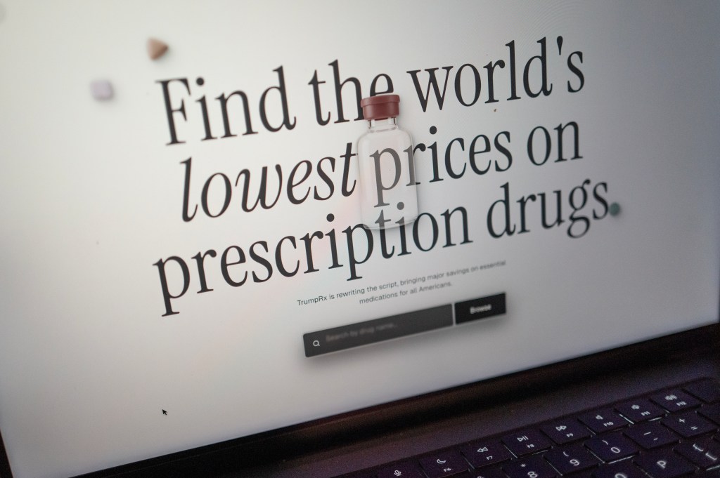 A photo of the TrumpRx website homepage on a laptop computer with the workds: "Find the world's lowest prices on prescription drugs."