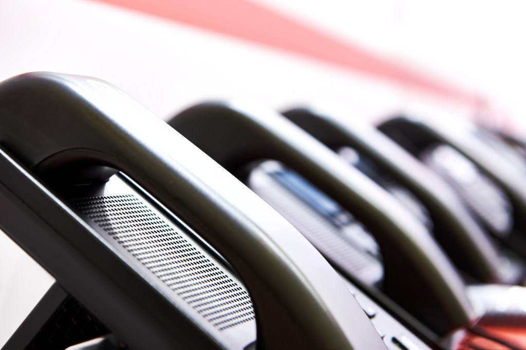 Handsets of black office phones in a row