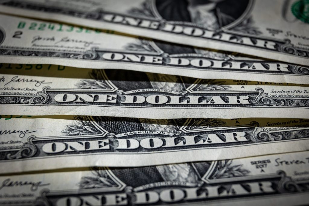 A stack of one dollar bills.