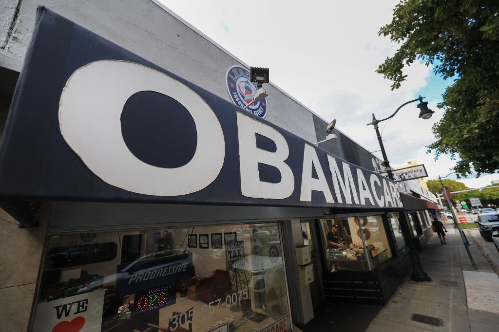 A photo of a store front awning sign reading "OBAMACARE" in large, all capitalized letters.
