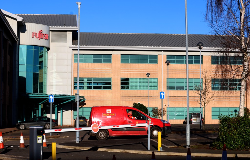 A Royal Mail post van delivers parcels at the Warrington offices of technology company Fujitsu.